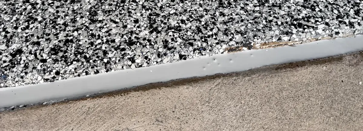 Repaired garage door edge with a clean coated finish, by Iron Cross
