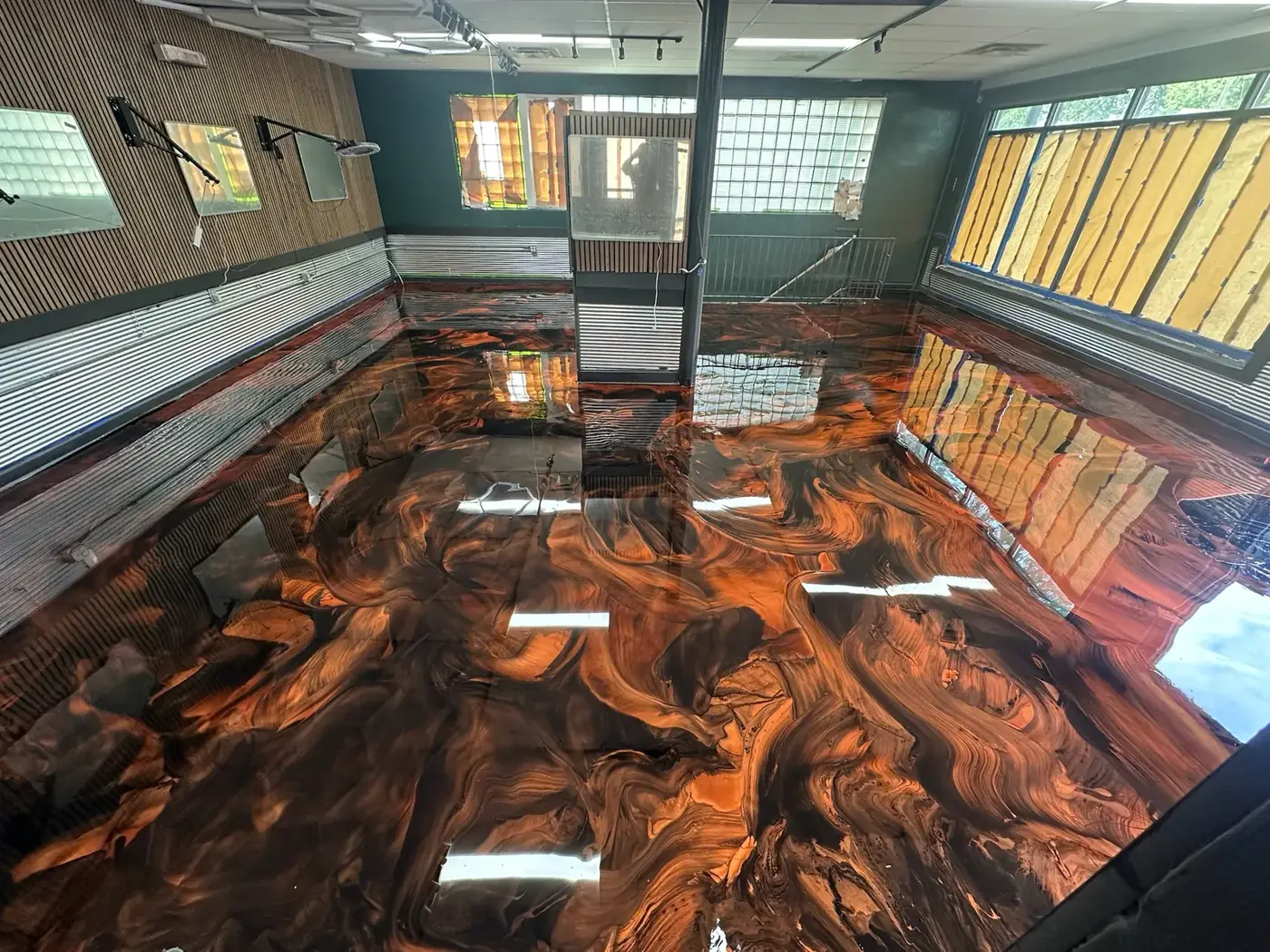 High-gloss copper and black metallic epoxy floor in a commercial space