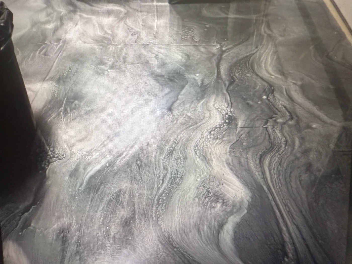 Silver, white and charcoal metallic epoxy with marble-like swirls, poured by Iron Cross